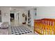 View of bedroom featuring an interior entry way, a crib, and wood-look floors at 2482 Kings Grant Rd, Lincolnton, NC 28092