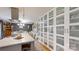 Modern kitchen with central island and long wall of white cabinets for pantry storage at 2482 Kings Grant Rd, Lincolnton, NC 28092