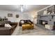 Comfortable living room area featuring a fireplace, leather sofas, and stylish decor at 2482 Kings Grant Rd, Lincolnton, NC 28092