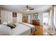 Main bedroom featuring hardwood floors, closet doors, and dark wood furniture, plus ensuite bathroom access at 2482 Kings Grant Rd, Lincolnton, NC 28092