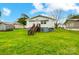 Expansive backyard with a bright green lawn, wooden deck, and partial home view at 26 Park Dr, Gastonia, NC 28054