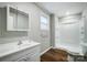 Bathroom featuring a stand-up shower, white vanity, and wood-style floors at 26 Park Dr, Gastonia, NC 28054
