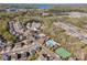 Panoramic aerial view of a community with a pool, clubhouse, tennis courts, and a nearby lake at 276 Annatto Way, Tega Cay, SC 29708