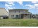 Spacious backyard with a well-maintained lawn and screened porch of the house at 276 Annatto Way, Tega Cay, SC 29708