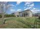 Expansive backyard with lush grass, view of the house, and mature trees at 276 Annatto Way, Tega Cay, SC 29708