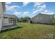 Lush backyard featuring the screened porch and plenty of green space at 276 Annatto Way, Tega Cay, SC 29708