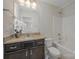 Bright bathroom featuring granite countertops, a framed mirror, and a shower-tub combo at 276 Annatto Way, Tega Cay, SC 29708