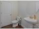 Half bathroom featuring a pedestal sink, round mirror and white trim at 276 Annatto Way, Tega Cay, SC 29708