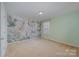 Bright Bedroom features an animal-themed accent wall and neutral carpeting at 276 Annatto Way, Tega Cay, SC 29708