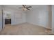 Neutral bedroom with a ceiling fan and private bathroom entrance at 276 Annatto Way, Tega Cay, SC 29708
