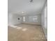 Large bonus room with neutral carpet, natural light, and versatile space at 276 Annatto Way, Tega Cay, SC 29708