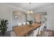 Bright dining room featuring a wood table, chandelier lighting, and access to the living room at 276 Annatto Way, Tega Cay, SC 29708
