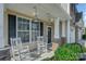 Charming front porch with rocking chairs and stylish lighting, inviting you to relax and enjoy the outdoors at 276 Annatto Way, Tega Cay, SC 29708