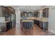 Modern kitchen featuring dark cabinetry, stainless steel appliances, granite counters, and a center island at 276 Annatto Way, Tega Cay, SC 29708