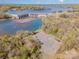 Aerial view of a lake dam, surrounded by lush greenery, showcasing the natural beauty at 276 Annatto Way, Tega Cay, SC 29708