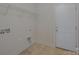 Simple laundry room with tile floor, storage shelf, and utility connections at 276 Annatto Way, Tega Cay, SC 29708