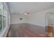 Empty living room featuring hardwood floors, neutral paint, and an open layout with many windows at 276 Annatto Way, Tega Cay, SC 29708