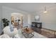 Spacious living room with hardwood floors, elegant furniture, and an open dining area at 276 Annatto Way, Tega Cay, SC 29708