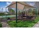 Community playground with shaded play structures, a basketball court, and picnic tables at 276 Annatto Way, Tega Cay, SC 29708
