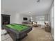 Entertainment room with a pool table, comfortable seating, and ample natural light at 276 Annatto Way, Tega Cay, SC 29708