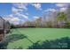 Bright tennis court with green surface, surrounded by trees and fencing, ready for a match at 276 Annatto Way, Tega Cay, SC 29708