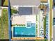 Aerial view showcases a large backyard pool with a spa, lounge area, and manicured lawn at 3124 Berry Creek Rd, Charlotte, NC 28214
