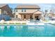 Gorgeous backyard featuring a pool, outdoor kitchen, covered patio, spa, and meticulously kept landscaping at 3124 Berry Creek Rd, Charlotte, NC 28214