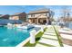 Resort-style backyard features a pool with a spa, lounge seating, and outdoor kitchen at 3124 Berry Creek Rd, Charlotte, NC 28214