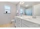 Well-lit bathroom featuring a double vanity, marble countertop, and neutral tiling at 3124 Berry Creek Rd, Charlotte, NC 28214