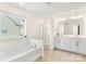 Bright bathroom featuring a double vanity, soaking tub, and separate shower stall at 3124 Berry Creek Rd, Charlotte, NC 28214