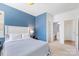 Comfortable bedroom featuring a blue accent wall and access to a bathroom and closet space at 3124 Berry Creek Rd, Charlotte, NC 28214