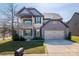 Charming two-story home with a covered porch, balcony, manicured lawn and attached two-car garage at 3124 Berry Creek Rd, Charlotte, NC 28214