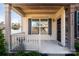 Inviting front porch featuring wood ceiling, a security camera, dark shutters and a grill at 3124 Berry Creek Rd, Charlotte, NC 28214