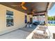 Charming covered patio features comfortable seating, ceiling fans, and ambient string lighting at 3124 Berry Creek Rd, Charlotte, NC 28214