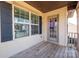 Cozy porch with wood flooring, window with dark shutters, and a glass paneled front door at 3124 Berry Creek Rd, Charlotte, NC 28214