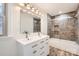 Modern bathroom features a double vanity with a tiled shower and tub combination at 3225 Liberty Rd, Gold Hill, NC 28071