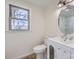 A pristine bathroom with a modern vanity, toilet, and a view from the window at 3225 Liberty Rd, Gold Hill, NC 28071