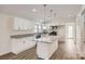 Modern kitchen with granite countertops, white cabinetry, and stainless steel appliances at 3225 Liberty Rd, Gold Hill, NC 28071