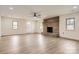 Spacious living room with a brick fireplace, ceiling fan and laminate floors at 3225 Liberty Rd, Gold Hill, NC 28071