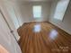 Cozy bedroom with wood-look flooring, neutral paint, and natural light from two windows at 325 Orr Dr, Rock Hill, SC 29730