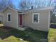 Charming single-story home with light beige siding, a red door, and a neatly landscaped front yard at 325 Orr Dr, Rock Hill, SC 29730