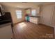 Bright kitchen featuring white cabinets, granite countertops, wood-look flooring, and stainless steel appliances at 325 Orr Dr, Rock Hill, SC 29730