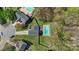 Aerial view showcasing the home, pool, and wooded lot at 3904 Crimson Wing Dr, Indian Trail, NC 28079