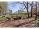 Backyard with fire pit and mature trees at 3904 Crimson Wing Dr, Indian Trail, NC 28079