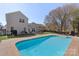 Spacious backyard with a pool, fire pit, and patio area at 3904 Crimson Wing Dr, Indian Trail, NC 28079
