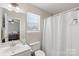 Bright bathroom featuring a large mirror, single vanity, and a shower with curtain at 3904 Crimson Wing Dr, Indian Trail, NC 28079