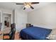 Cozy bedroom with wood flooring, ceiling fan, and spacious closet at 3904 Crimson Wing Dr, Indian Trail, NC 28079