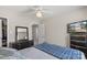 Well-lit bedroom with a ceiling fan, dresser, closet, and mounted television at 3904 Crimson Wing Dr, Indian Trail, NC 28079