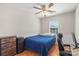 Comfortable bedroom with a ceiling fan, wood flooring, and a home office setup at 3904 Crimson Wing Dr, Indian Trail, NC 28079