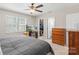 Well-lit bedroom featuring a ceiling fan, walk-in closet, and a mounted television at 3904 Crimson Wing Dr, Indian Trail, NC 28079